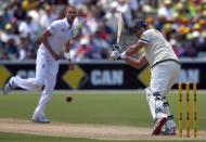 England's Stuart Broad (L) watches as Australia's Shane Watson hits a four during the first day's play in the second Ashes test cricket match at the Adelaide Oval December 5, 2013.