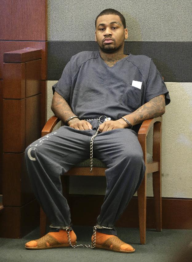 FILE - In this April 17, 2013 file photo, Ammar Harris sits in district court while awaiting his arraignment in Las Vegas. Sentencing is scheduled Wednesday, Feb. 26, 2014, for Harris, convicted of rape and robbery in one case while he awaits trial later this year in a separate Las Vegas Strip shooting and fiery crash that left three people dead. Harris faces a mandatory minimum of 10 years, and Clark County District Court Judge Kathleen Delaney could sentence him to up to life in prison. (AP Photo/Julie Jacobson, File)