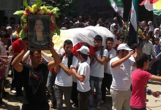 A handout image released by the Syrian opposition's Shaam News Network shows mourners carrying the coffin of Fadwa Khaled who was allegedly killed during the unrest in Qamishli. UN-Arab envoy Kofi Annan expressed "horror" at the Houla massacre of more than 100 people as he began a visit on Monday to the Syrian capital aimed at salvaging his battered peace plan