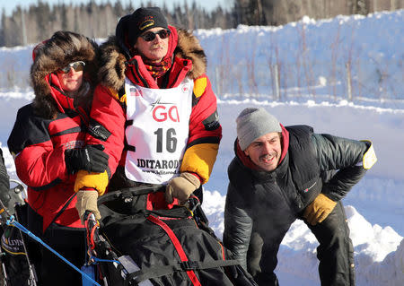 FILE PHOTO: Two-times champion Mitch Seavey waits with his wife at the official restart gate of the Iditarod, a nearly 1,000 mile (1,610 km) sled dog race across the Alaskan wilderness, in Fairbanks, Alaska, U.S. March 6, 2017. REUTERS/Nathaniel Wilder/File Photo