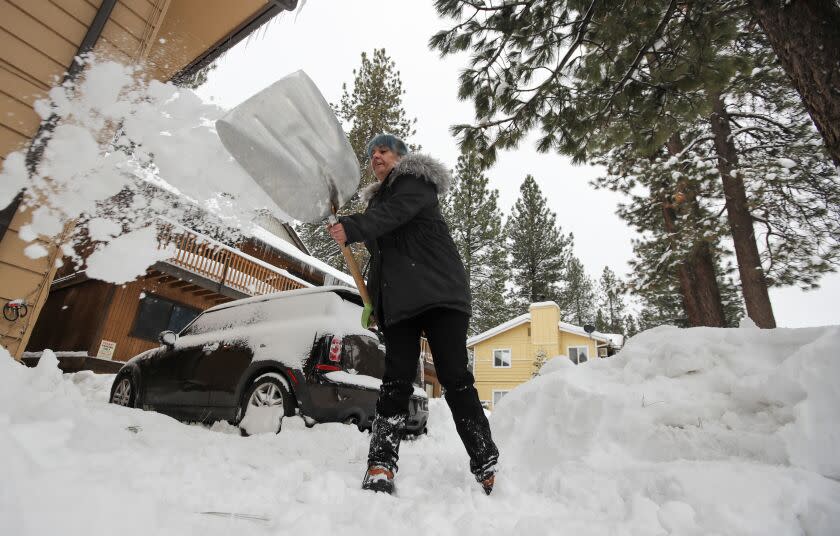 BIG BEAR LAKE, CA - FEBRUARY 28: Amblerlee Barden shovels snow after successive storms dumped several feet of snow blocking her driveway on Tuesday, Feb. 28, 2023 in Big Bear Lake, CA. (Brian van der Brug / Los Angeles Times)