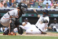 Detroit Tigers' Javier Baez, right, slides safely into home to score on a sacrifice fly by teammate Miguel Cabrera in the third inning of a baseball game against the Baltimore Orioles in Detroit, Sunday, May 15, 2022. (AP Photo/Lon Horwedel)