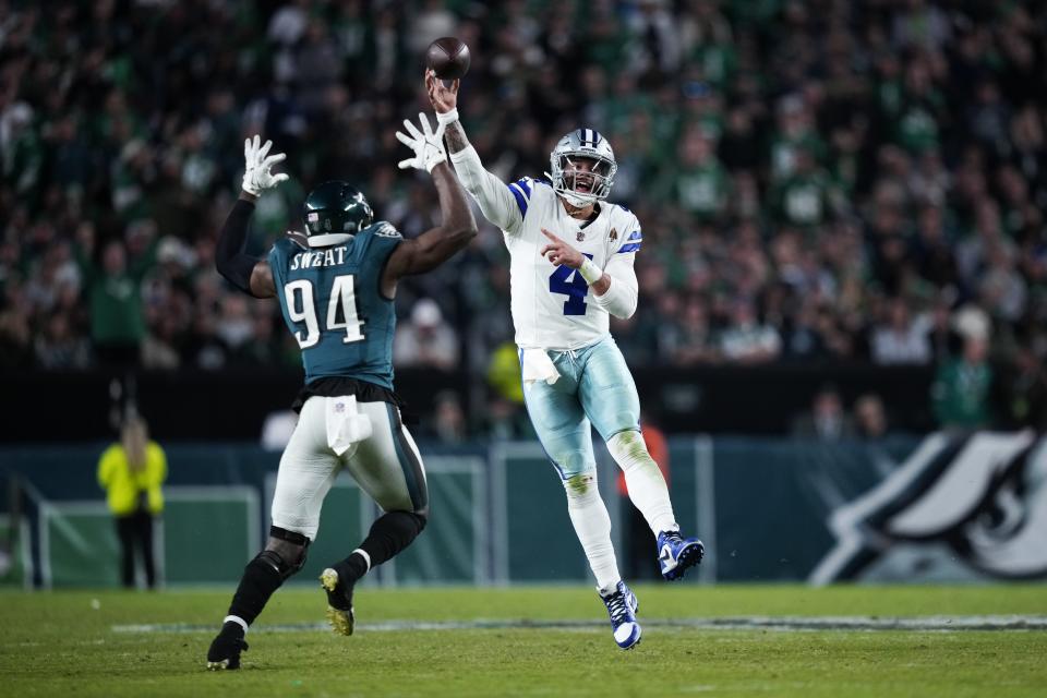 Dallas Cowboys quarterback Dak Prescott (4) passes over Philadelphia Eagles defensive end Josh Sweat (94) during the second half of an NFL football game Sunday, Nov. 5, 2023, in Philadelphia. (AP Photo/Matt Slocum)