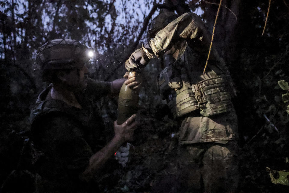 In this photo provided by the 24th Mechanised brigade press service, Ukrainian soldiers fire 120 mm mortar towards Russian position on the front line at Chasiv Yar in Donetsk region, Ukraine, Friday, June 21, 2024. (Oleg Petrasiuk/Ukrainian 24 Mechanised brigade via AP)