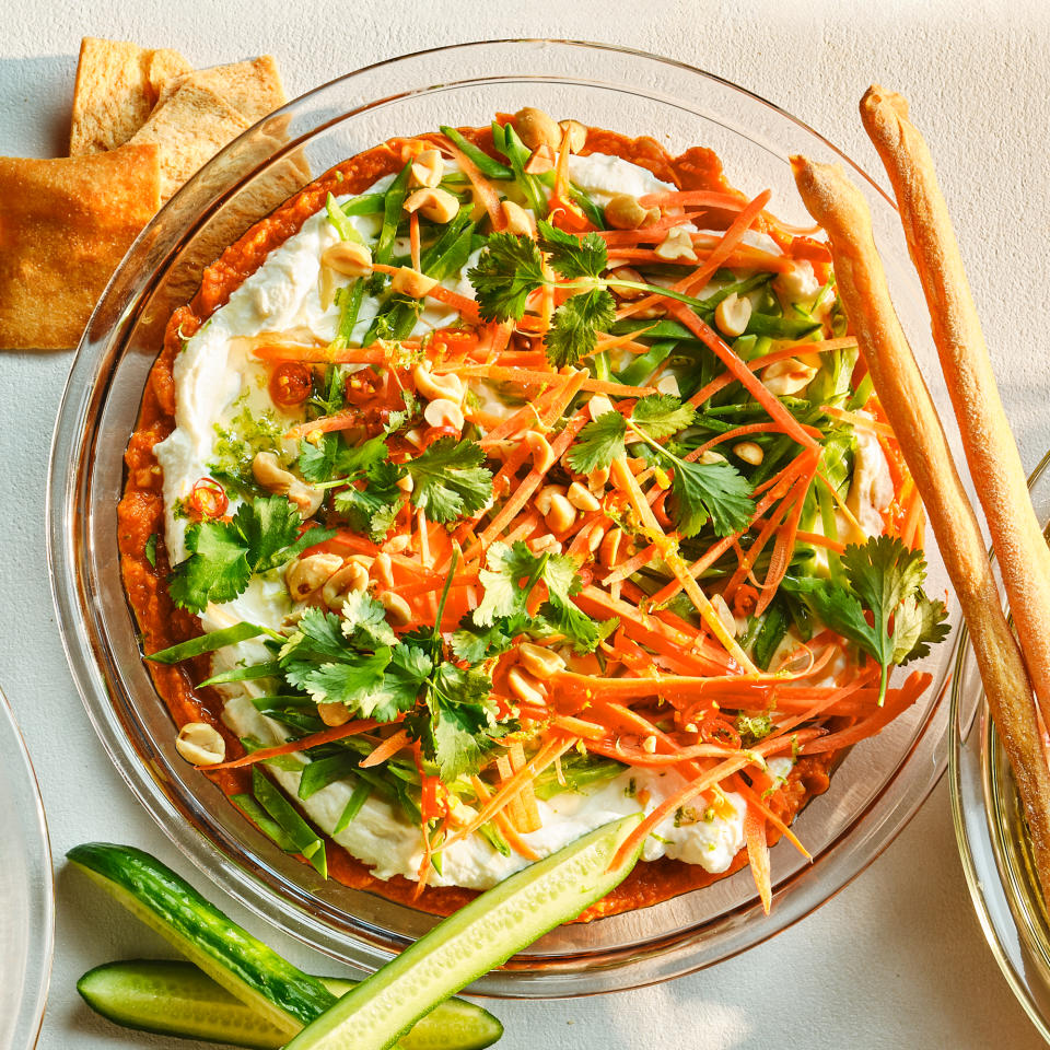 <p>Curry paste lends a pop of heat to this 7-layer dip, while carrots and snap peas add fresh crunch on top. Look for roasted peanut oil for the strongest nutty flavor. <a href="https://www.eatingwell.com/recipe/7960810/thai-chile-curry-dip/" rel="nofollow noopener" target="_blank" data-ylk="slk:View Recipe" class="link ">View Recipe</a></p>