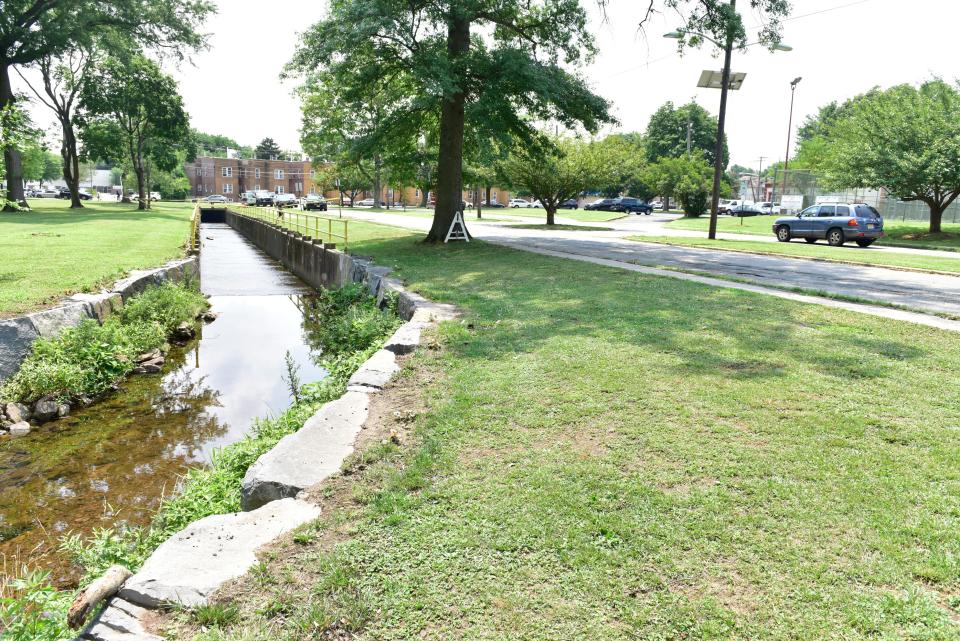 Emergency personnel search and find a Toyota Prius that was swept away into a canal on Monday July 6, 2020 in Passaic, N.J. The car was found under Brook Ave near River Drive on Wednesday afternoon. Rutherford Police Chief John Russo said the woman was "shot out," swam to the other side of the river and climbed out on his borough's banks into a backyard on Carneer Avenue.