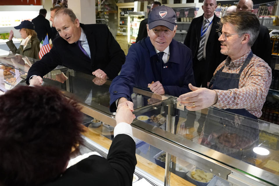 President Joe Biden and Micheál Martin, Tánaiste of Ireland, greet workers at McAteers The Food House with owner Jerome McAteer, right, in Dundalk, Ireland, Wednesday, April 12, 2023. (AP Photo/Patrick Semansky)