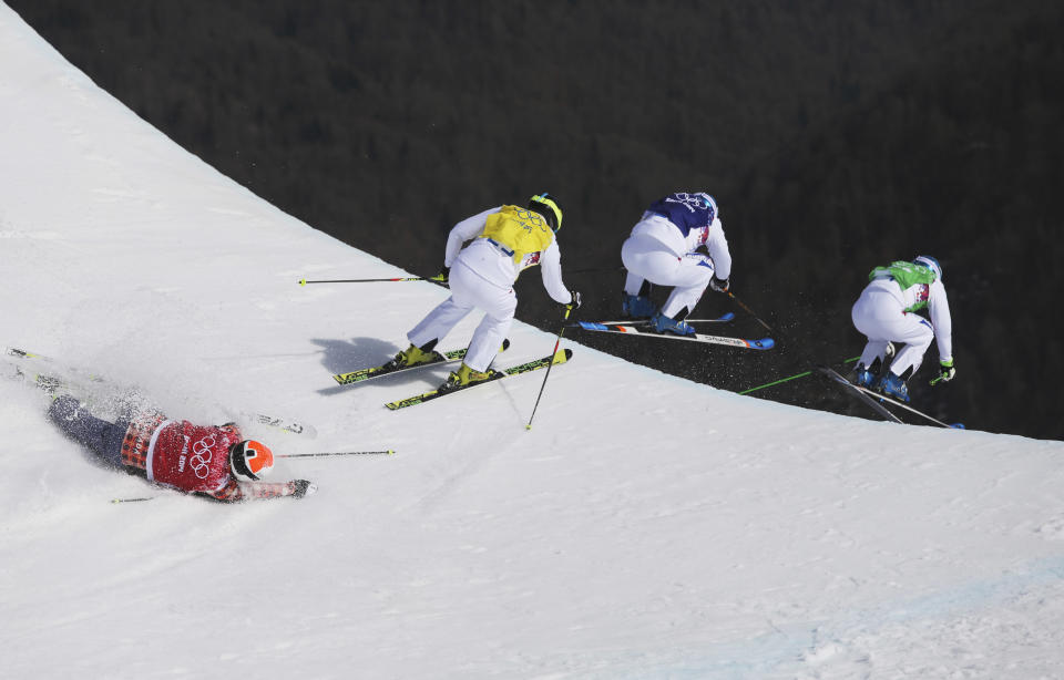 Jean Frederic Chapuis of France, right, leads compatriots Arnaud Bovolenta, second right, and Jonathan Midol, third right, as Canada's Brady Leman crashes in the men's ski cross final at the 2014 Winter Olympics, at the Rosa Khutor Extreme Park, Krasnaya Polyana, Russia, on Feb. 20, 2014. 