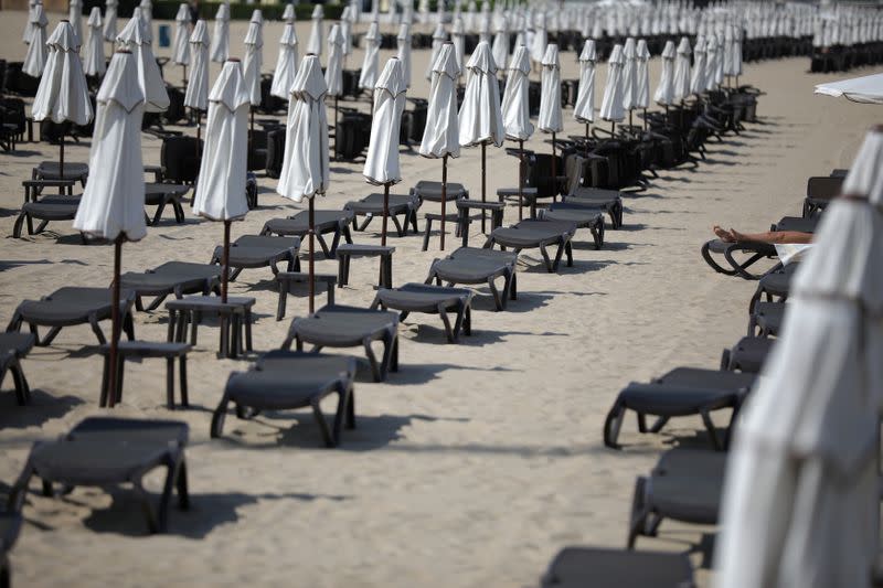 Tourist rests near empty sunbeds at Sunny Beach resort on the Black Sea