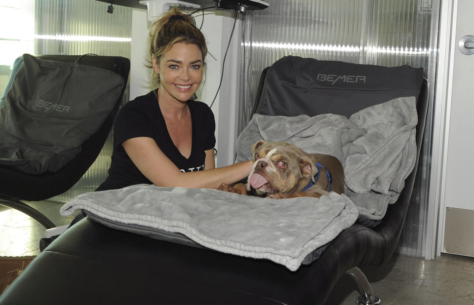 <p>Denise Richards spends her day quarantined with her husband Aaron Phypers at his Q360 healing center in Malibu, California, helping dogs in need from Road Dogs & Rescue.</p>