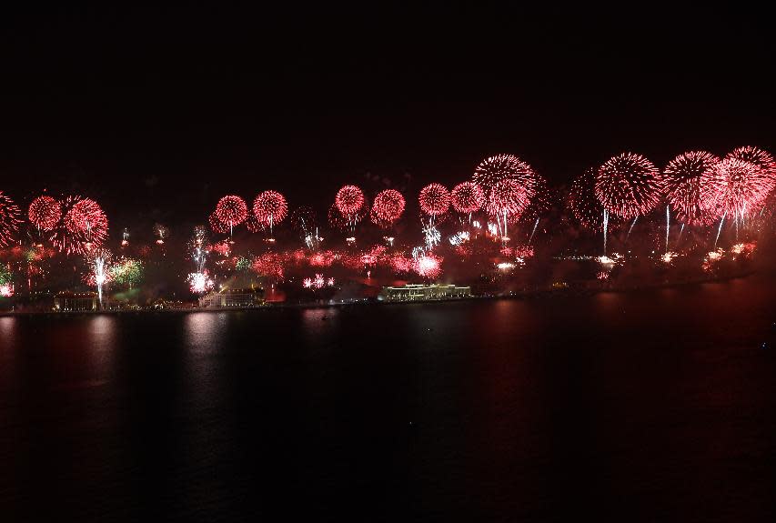 Fireworks explode over the Jumeirah Palm Island at midnight to celebrate the New Year, Wednesday, Jan. 1, 2014, in Dubai, United Arab Emirates. (AP Photo/Kamran Jebreili)