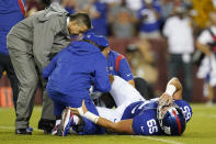 New York Giants center Nick Gates (65) lays on the field as members of the team medical staff tend to him during the first half of an NFL football game against the Washington Football Team, Thursday, Sept. 16, 2021, in Landover, Md. Gates sustained an injury on the play and was carted off the field. (AP Photo/Patrick Semansky)