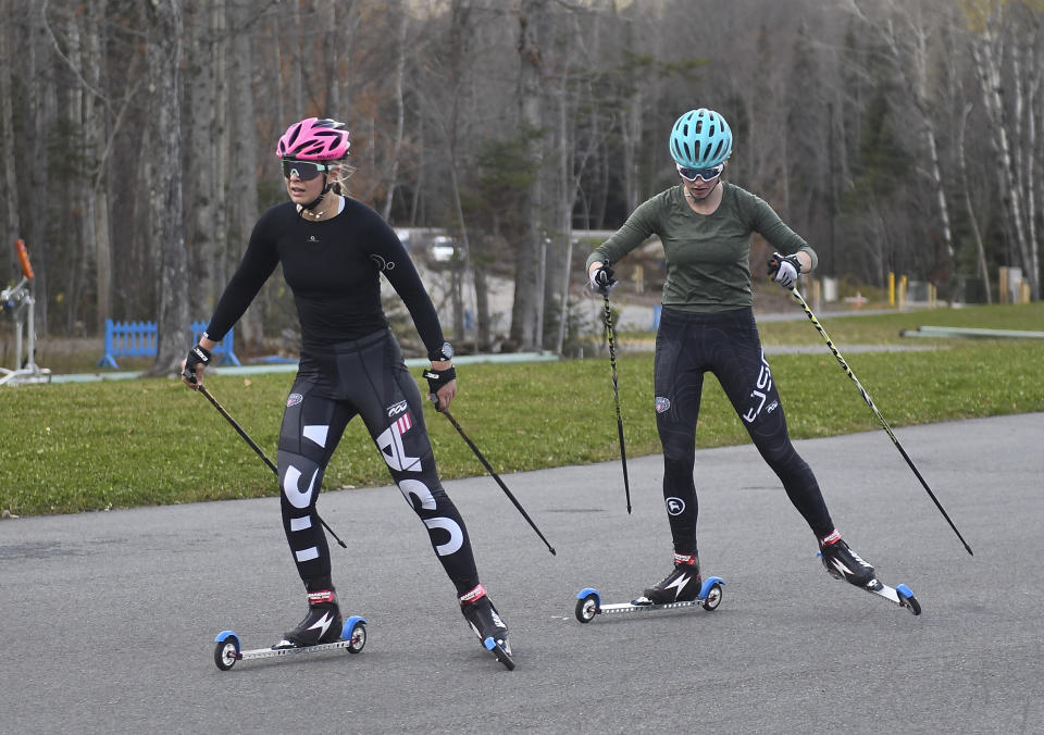 Annika Malacinski, left, and Alexa Brabec take part in a roller ski training session for the 2022 U.S. Olympic team for Nordic combined and ski jumping teams at Mount Van Hoevenberg Olympic Sports Complex in Lake Placid, N.Y., Thursday, Nov. 4, 2021. Even before the U.S. teams were set for Beijing Games, 20-year-old Annika Malacinski knew she had no shot at competing in China because she is a woman. Nordic combined, which combines ski jumping and cross-country skiing, is the only Olympic sport without gender equity. (AP Photo/Hans Pennink)