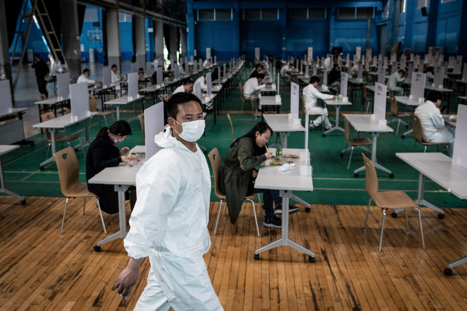 This photo taken on April 7, 2020 shows employees eating during lunch break at an auto plant of Dongfeng Honda in Wuhan in China's central Hubei province. - Thousands of relieved citizens streamed out of China's Wuhan on April 8 after authorities lifted months of lockdown at the coronavirus epicntre, offering some hope to the world despite record deaths in Europe and the United States. (Photo by STR / AFP) / China OUT (Photo by STR/AFP via Getty Images)