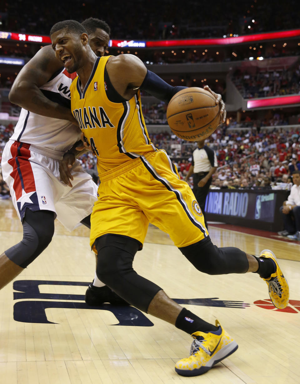 Indiana Pacers forward Paul George, front, drives past Washington Wizards forward Martell Webster during the second half of Game 4 of an Eastern Conference semifinal NBA basketball playoff game in Washington, Sunday, May 11, 2014. (AP Photo/Alex Brandon)