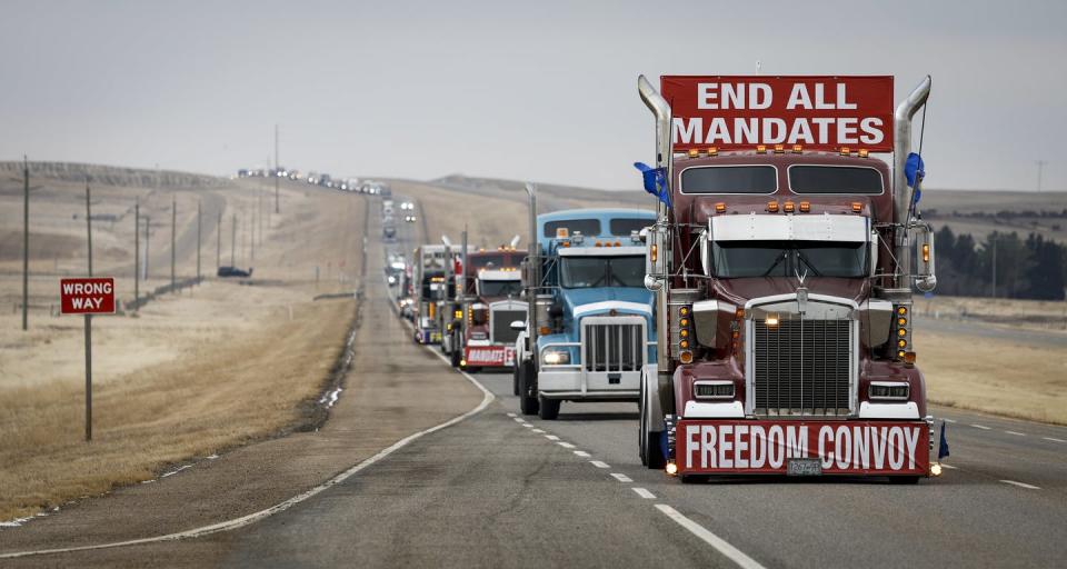 <span class="caption">Anti-vaccine mandate demonstrators leave in a truck convoy after blocking the highway at the busy U.S. border crossing in Coutts, Alta., in February 2022.</span> <span class="attribution"><span class="source">THE CANADIAN PRESS/Jeff McIntosh</span></span>