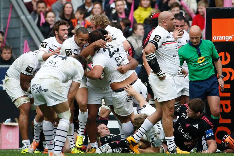 Toulouse's players celebrate after prop Yohan Montes scored a try during a French Top 14 rugby union match against Stade Francais on March 22, 2014, at the Stade de France in Saint-Denis, north of Paris