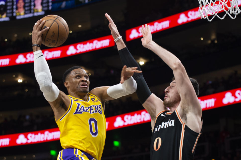 Los Angeles Lakers guard Russell Westbrook scores against Atlanta Hawks forward Frank Kaminsky during the first half of an NBA basketball game Friday, Dec. 30, 2022, in Atlanta. (AP Photo/Hakim Wright Sr.)