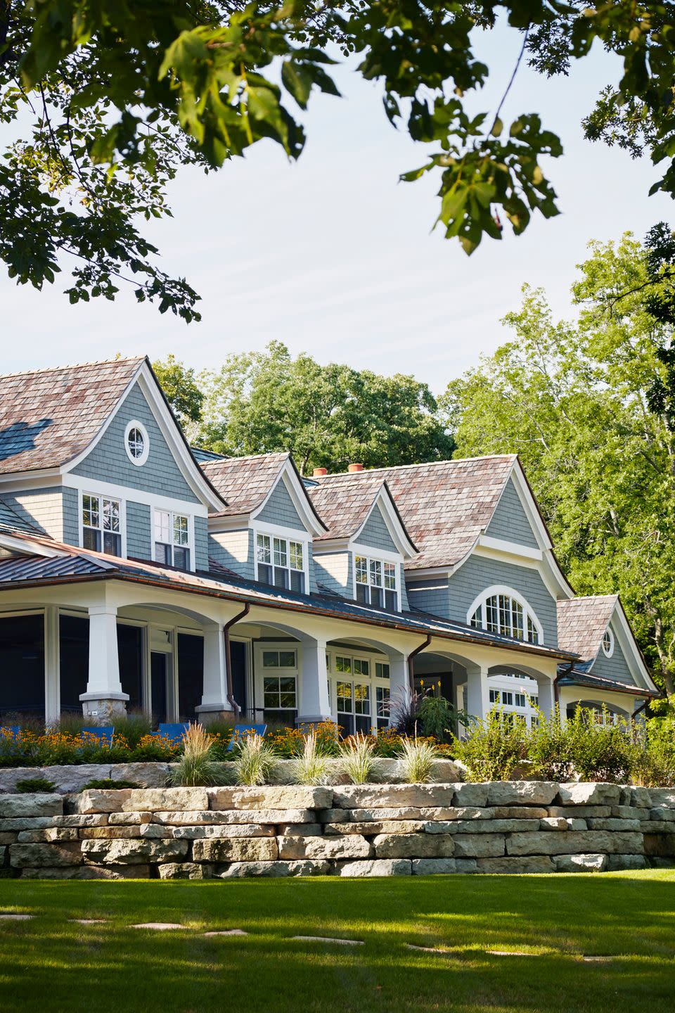 a large house with a stone wall