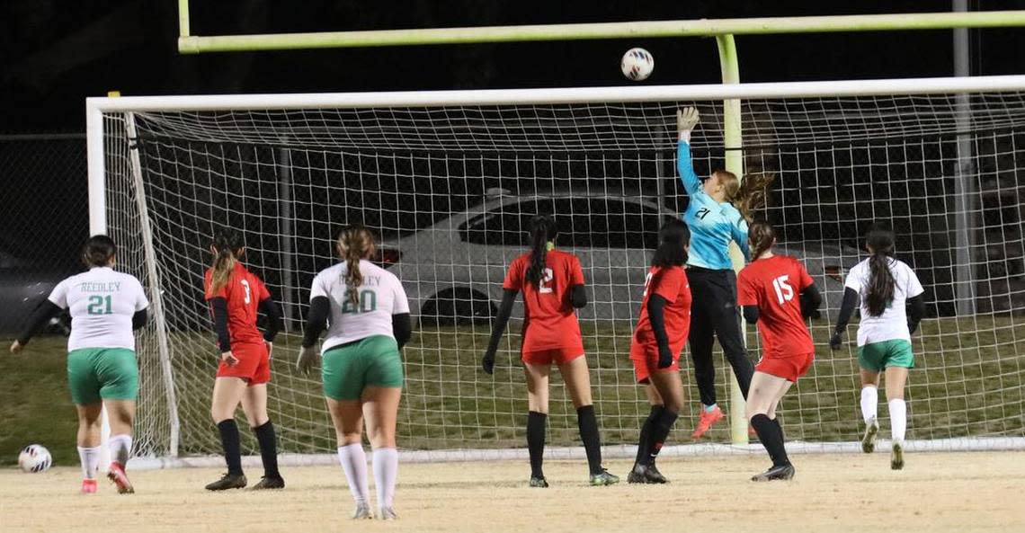 Fowler High goalkeeper Chloe Ávila leaps high to make sure a free kick by Reedley High goes over the net during a CIF Central Section Division IV girls soccer match on Feb. 15, 2023 at Fowler High. Second-seeded Fowler advanced with a 5-0 win.