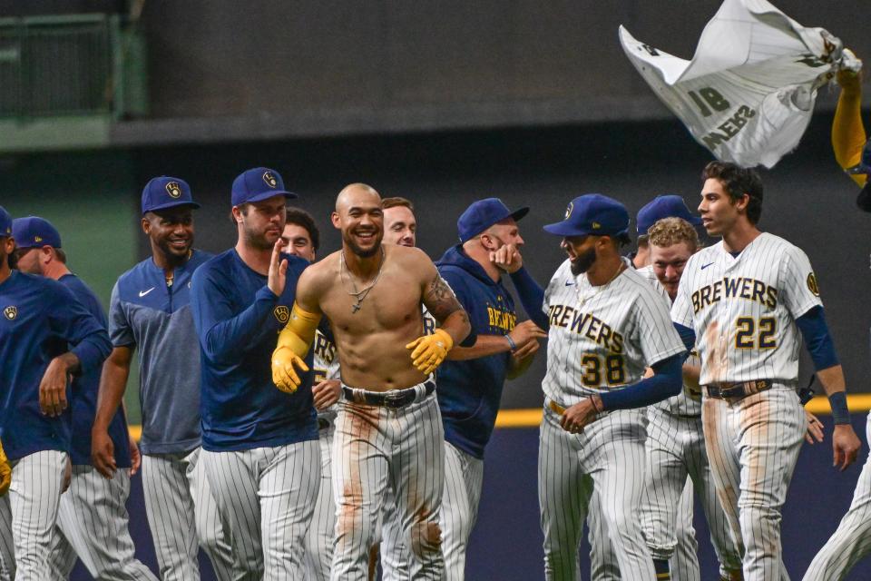 Brewers outfielder Blake Perkins celebrates with teammates after driving in the winning run with a base hit in the 10th inning.