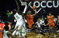 Oregon State guard Gianni Hunt (0) drives to the basket as Oregon forward Lok Wur (15) defends on the play during the first half of an NCAA college basketball game Saturday, Jan. 23, 2021, in Eugene, Ore. (AP Photo/Andy Nelson)