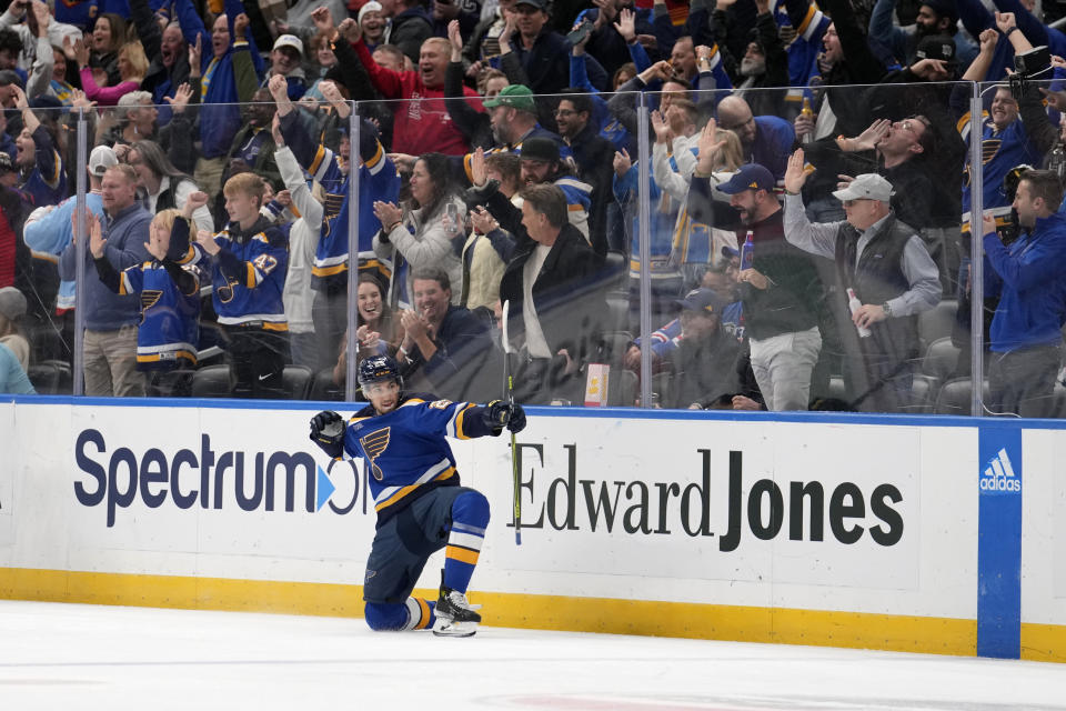 St. Louis Blues' Jordan Kyrou celebrates after scoring a hat trick during the third period of an NHL hockey game against the New York Rangers Thursday, Jan. 11, 2024, in St. Louis. (AP Photo/Jeff Roberson)