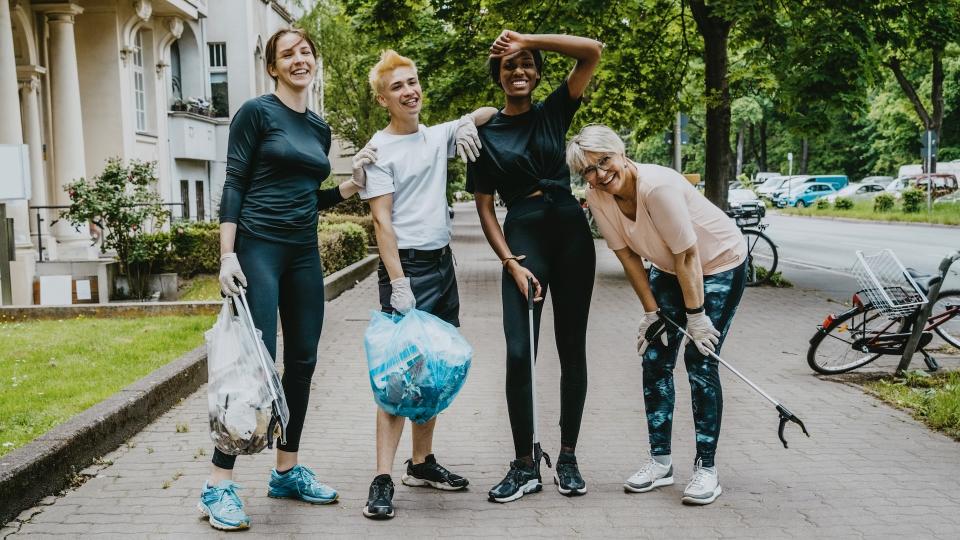 Four people taking a break from plogging