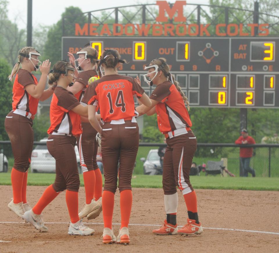 The Lady Colt infield celebrates at the mound after getting an out during Monday's Division III sectional semifinal with St. Clairsville in Byesville.