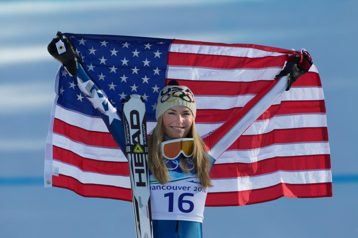 Lindsey Vonn holds up the flag after winning gold in the women's downhill competition at the 2010 Winter Olympics, Feb. 17, 2010. (Photo: Tim Clayton - Corbis via Getty Images)