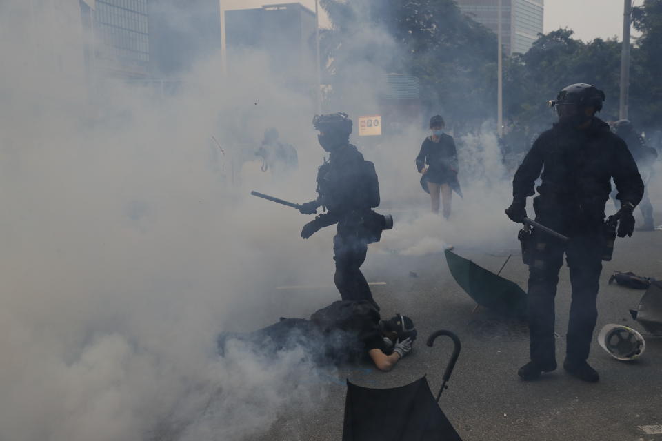 Police use tear smoke on protestors in Hong Kong, Sunday, Sept. 29, 2019. Riot police fired tear gas Sunday after a large crowd of protesters at a Hong Kong shopping district ignored warnings to disperse in a second straight day of clashes, sparking fears of more violence ahead of China's National Day. (AP Photo/Kin Cheung)