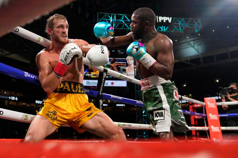 Floyd Mayweather throws a punch at Logan Paul during a boxing match at Hard Rock Stadium in Miami Gardens, Fla.