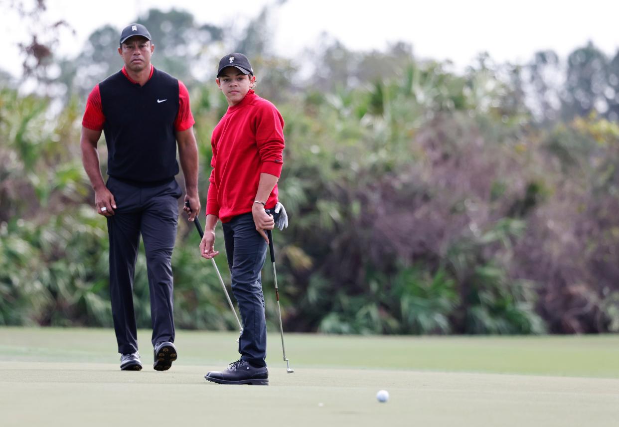 Tiger Woods, and son Charlie Woods watch a putt on the third green during the final round of the PNC Championship golf tournament at Ritz Carlton Golf Club Grande Lakes Orlando Course.
