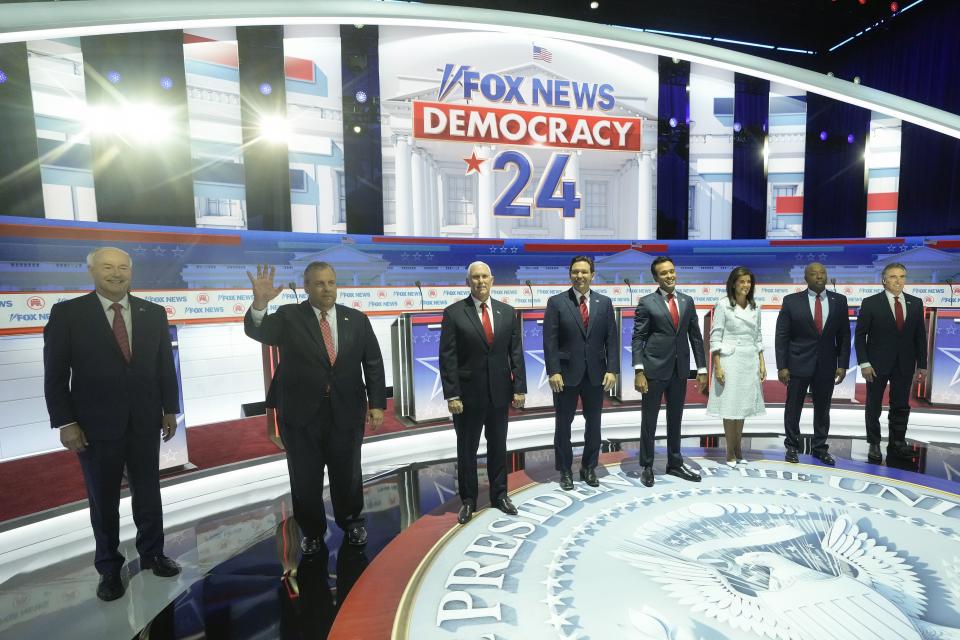 Republican presidential candidates stand on stage before a Republican presidential primary debate in Milwaukee.