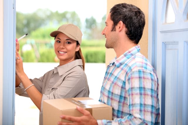 man receiving package from a delivery girl