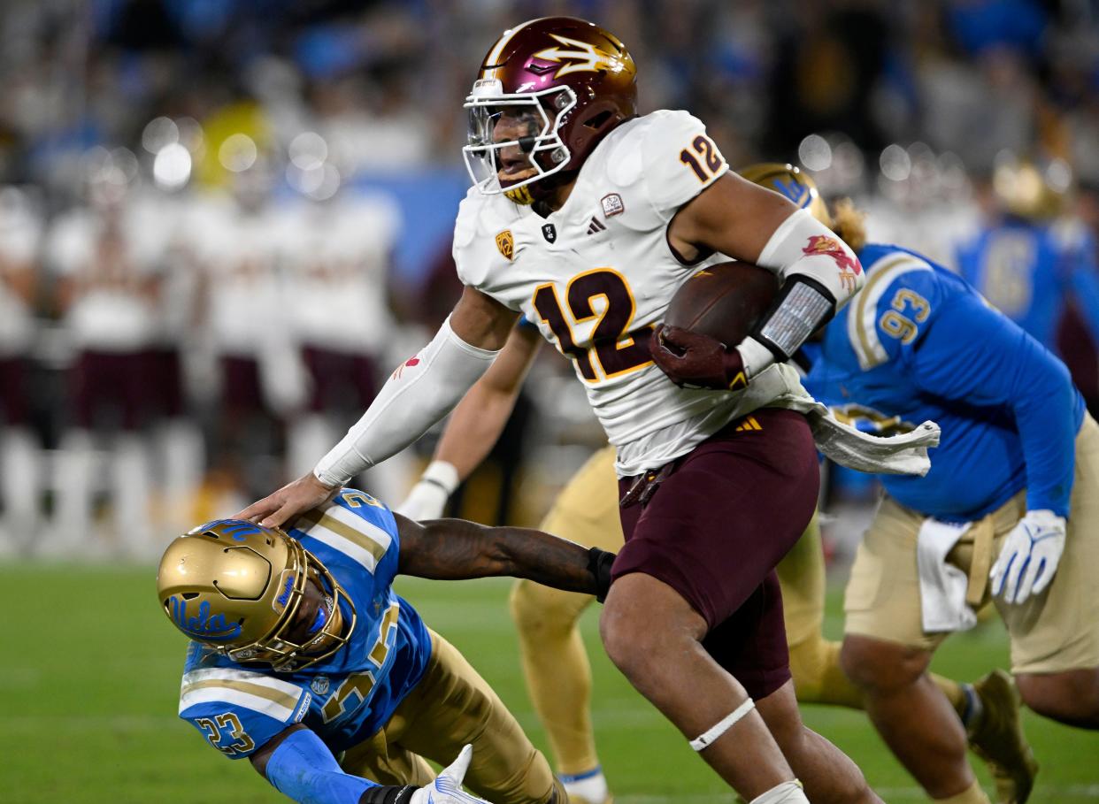 Arizona State Sun Devils tight end Jalin Conyers (12) pushes away UCLA Bruins defensive back Kenny Churchwell III (23) on a run during the first half at the Rose Bowl Nov. 11 in Pasadena, California.
