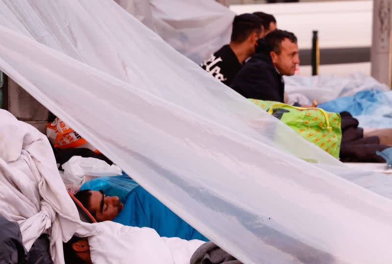 An asylum seeker sleeps on a street in central Brussels