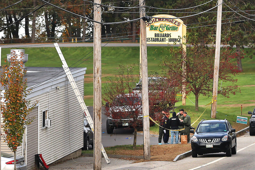 Police stand by the scene of the mass shooting in Lewiston Maine