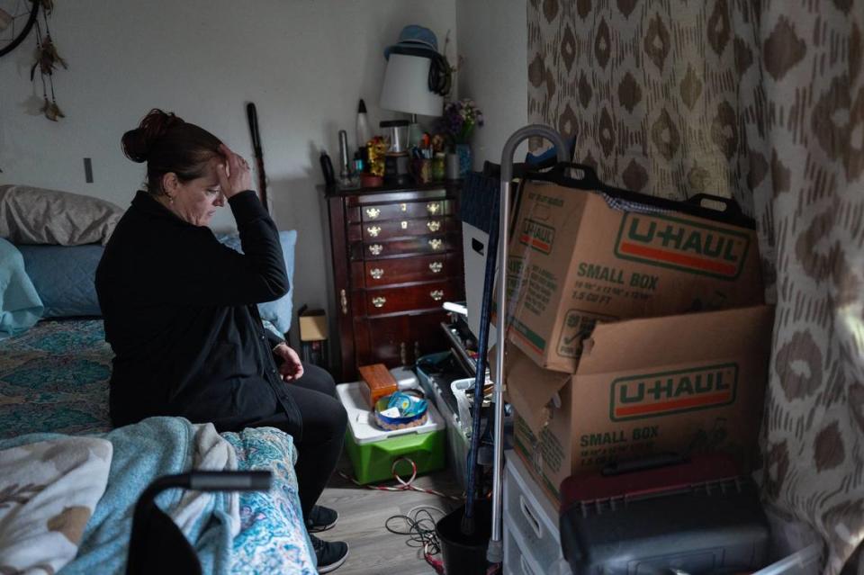 Brenda White, 49, who has Type 2 diabetes, shows signs of stress in March as she and her husband pack before being evicted from the Auburn Oaks complex. They had been placed in the former senior living facility after the state’s Project Roomkey program ended. Even though they had no place to move, they decided to vacate to avoid having the eviction in their court records for future prospective landlords to see.