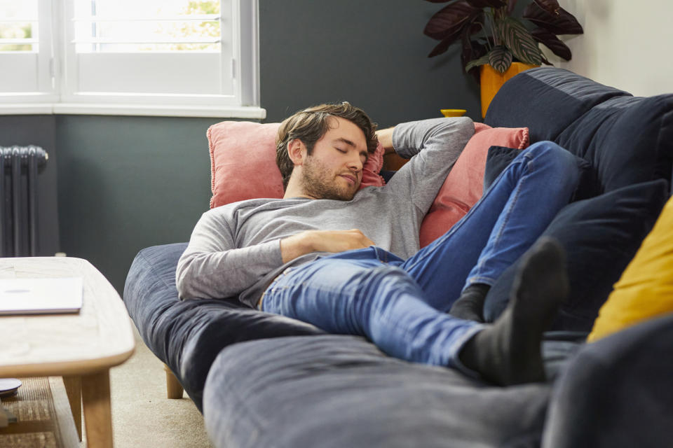 A man sleeping on his couch