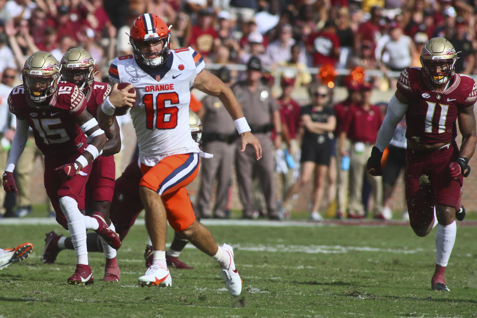 Syracuse quarterback Garrett Shrader (16) races past Florida State defenders for a 55-yard touchdown in the second quarter of an NCAA college football game Saturday, Oct. 2, 2021, in Tallahassee, Fla. (AP Photo/Phil Sears)