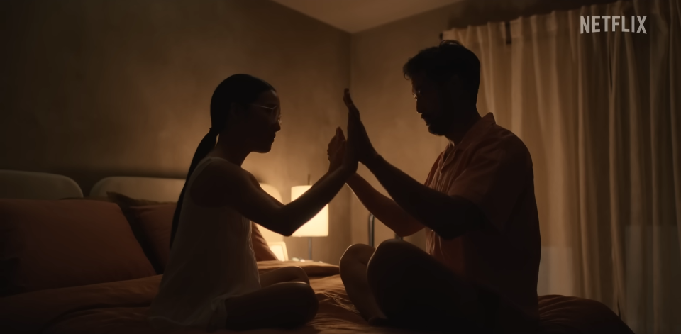 Joseph Lee and Ali Wong as George and Amy on their bed in "Beef"
