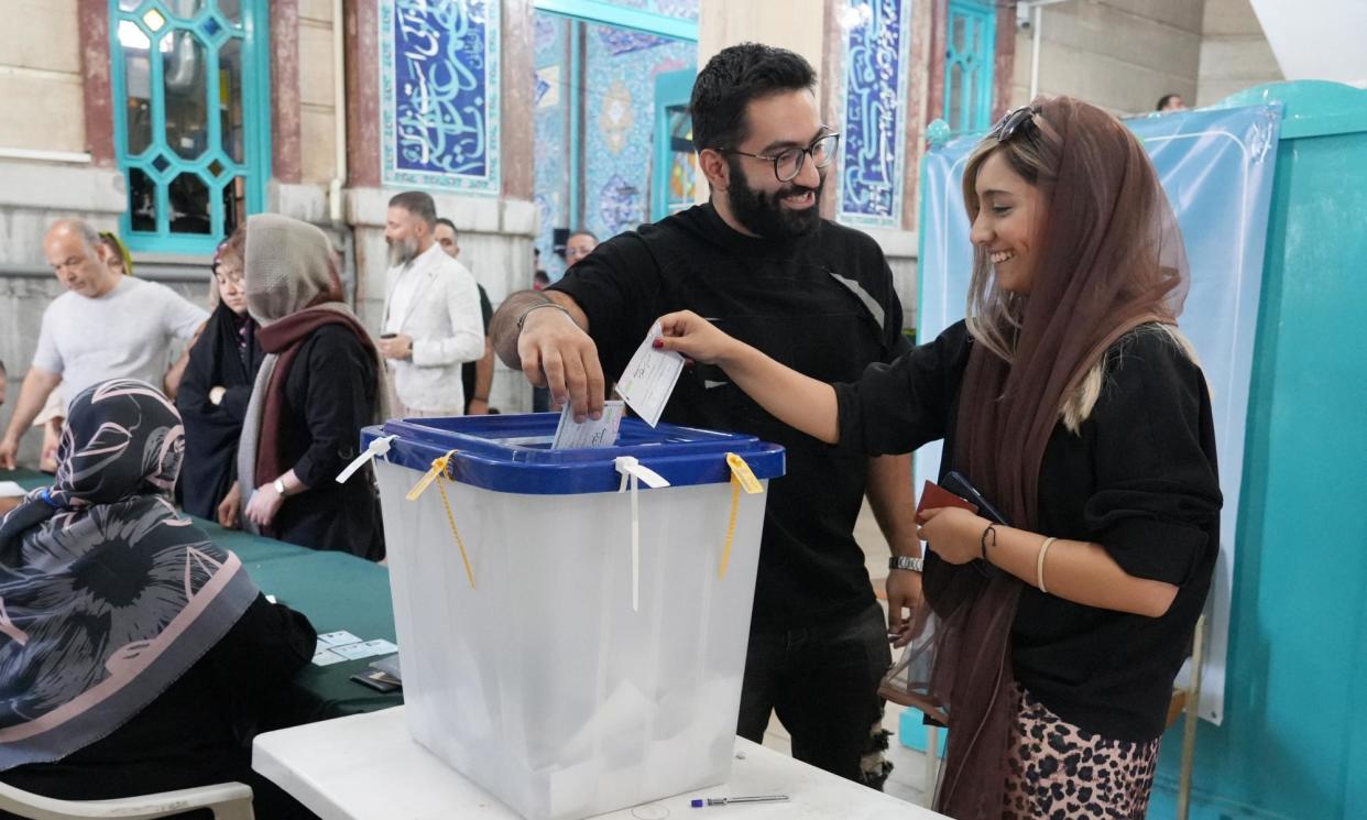 <span>Iranians cast their ballot at a polling station in Tehran.</span><span>Photograph: Raheb Homavandi/AFP/Getty</span>