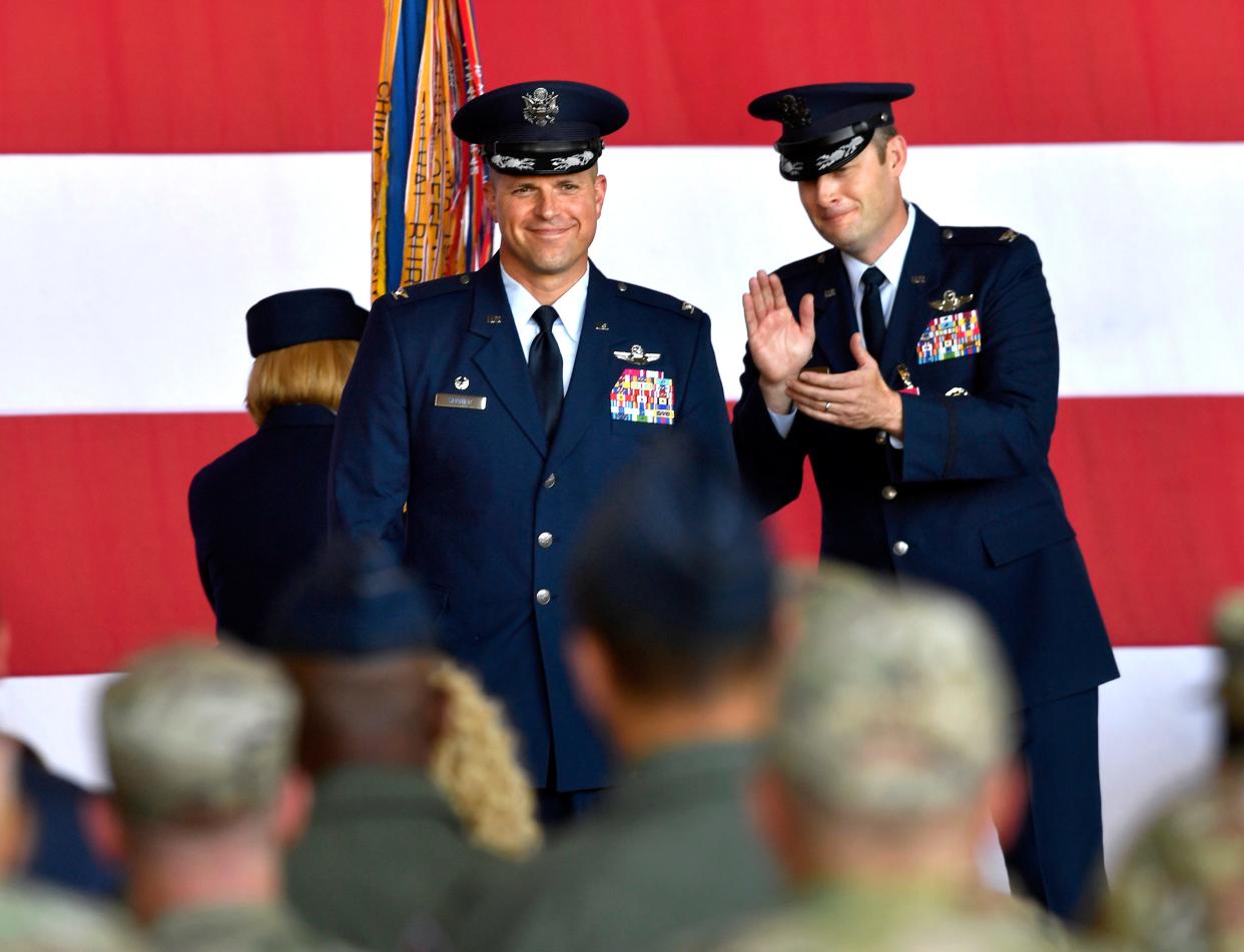 Outgoing 7th Bomb Wing commander Col. Joseph Kramer applauds his relief Col. Seth Spanier during Monday’s 7th Bomb Wing change of command ceremony at Dyess Air Force Base.
