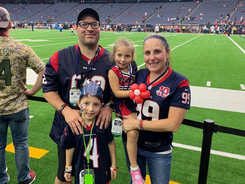 United Airlines flight attendants Rene and Jessica Trujillo pose with their children at NRG Stadium in Houston