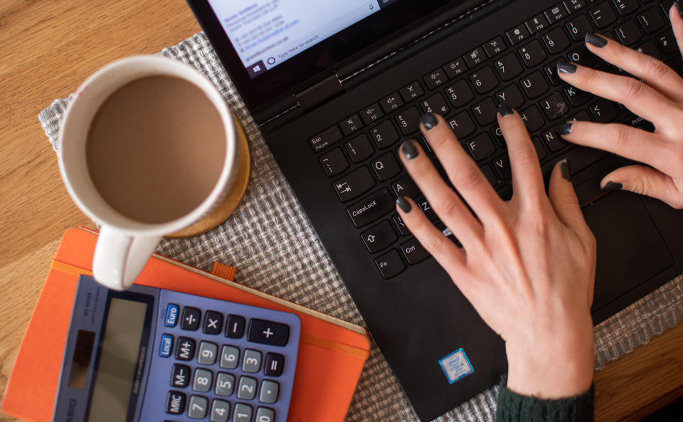 A woman using a laptop on a dining room table set up as a remote office to work from home. Workers told to self-isolate due to coronavirus will receive sick pay from day one, the Prime Minister has announced, as England's Chief Medical Officer warned that a UK epidemic is now "likely". PA Photo. Picture date: Wednesday March 4, 2020. See PA story HEALTH Coronavirus. Photo credit should read: Joe Giddens/PA Wire