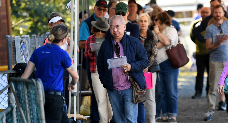 People line up to receive a coronavirus vaccination at the Rocklea Showgrounds in Brisbane, Saturday, June 5, 2021. The Queensland government has launched a drive to fully vaccinate all private aged care and disability workers against COVID-19 within three weeks, with 18 hubs across the state opening from Saturday. (AAP Image/Dan Peled) NO ARCHIVING