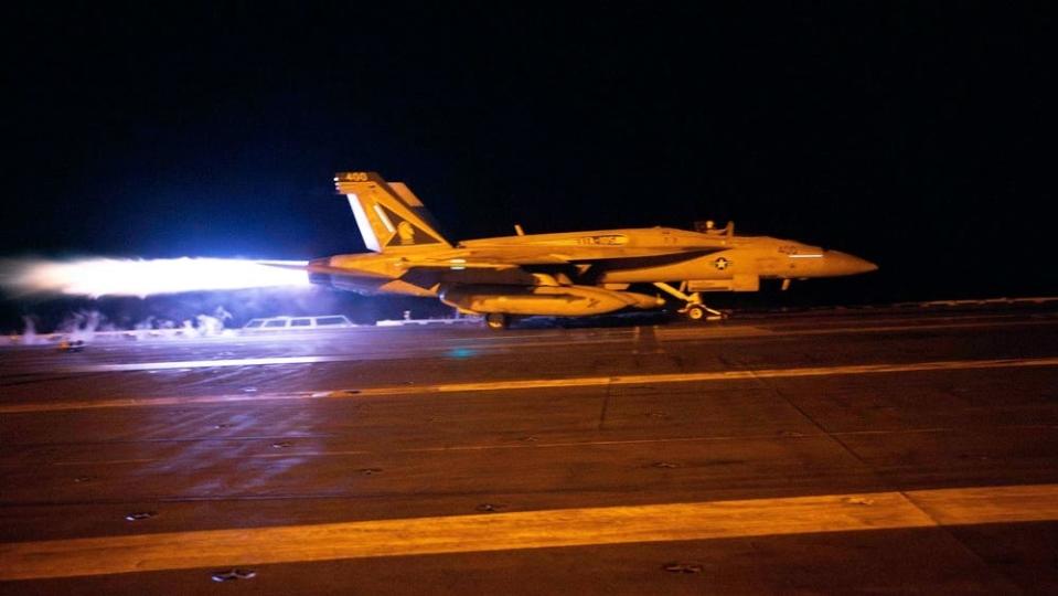 an aircraft takes off on the flight deck of a military carrier