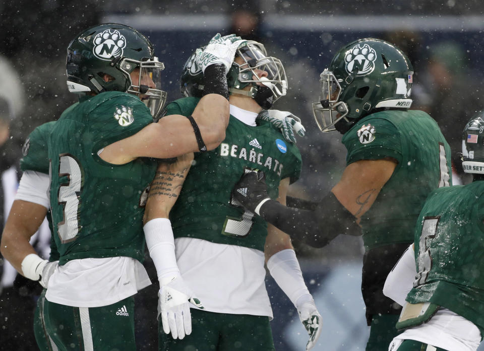 Northwest Missouri State cornerback Jack Young (5) celebrates with Jacob Vollstedt (43) and Kyle Goodburn (4) after intercepting a pass in the end zone against North Alabama in the first half of an NCAA Division II championship football game Saturday, Dec. 17, 2016, in Kansas City, Kan. (AP Photo/Colin E. Braley)