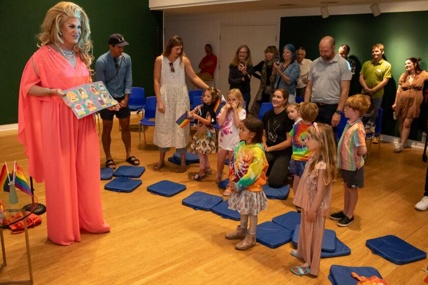LAGUNA BEACH, CA - JUNE 17: Drag Queen Pickle, left, reads a story to children during Drag Queen Story Hour at Laguna Art Museum, Laguna Beach, CA. (Irfan Khan / Los Angeles Times)